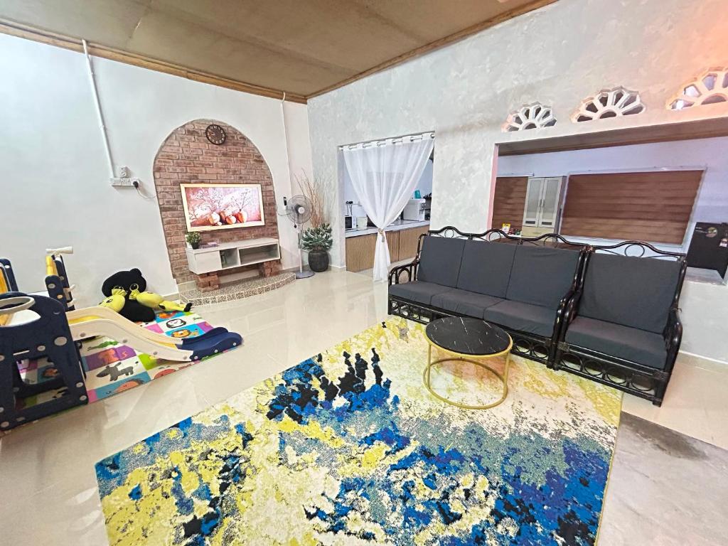 a living room with a couch and a rug at Rumah Singgah in Bentong