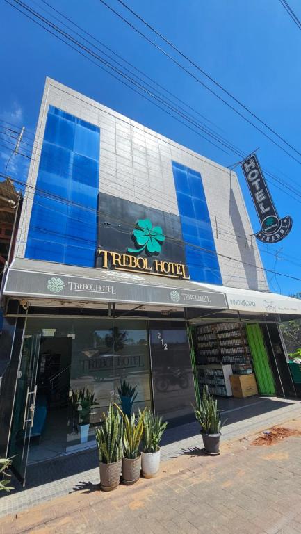 a tepoz hotel with potted plants in front of it at Trébol Hotel in Yurimaguas