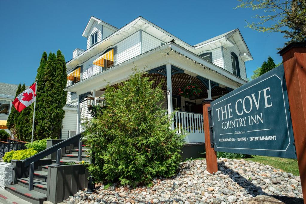 a house with a sign that reads the cove country inn at The Cove Inn in Westport