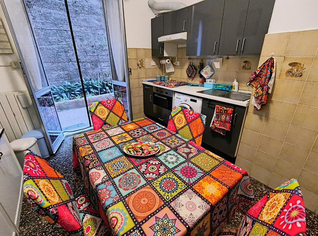 a kitchen with a table with colorful pillows at Pineta Holiday Home in Genoa