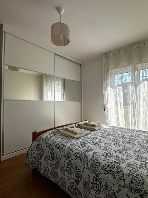 a bedroom with a bed and a large mirror at Apartamento Jardim do Sol in Macedo de Cavaleiros