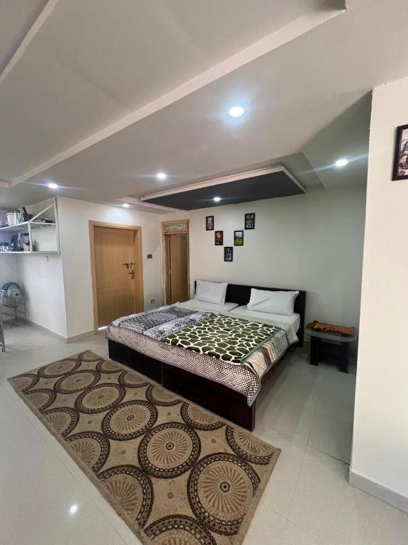 a bedroom with a large bed with a rug at Nathigali A & M resort in Nathia Gali