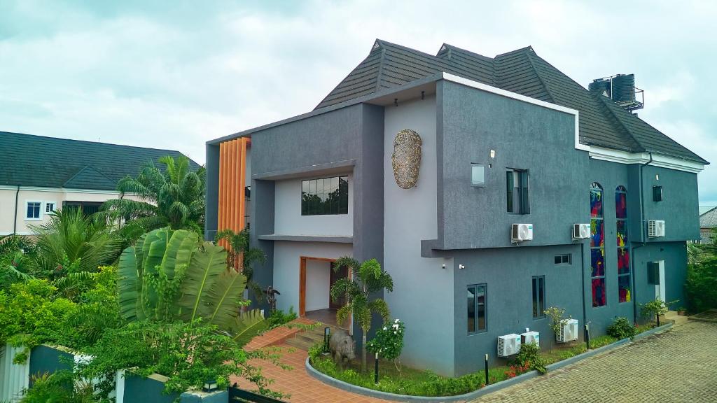 a house with a gray and white at Black Muse Residence in Benin City
