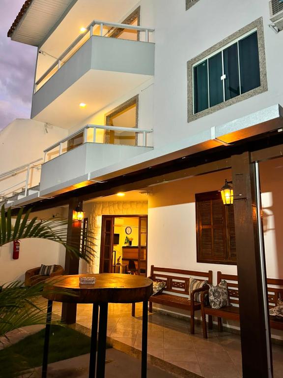 a house with a table in front of it at DLUX Hotel in Campos dos Goytacazes