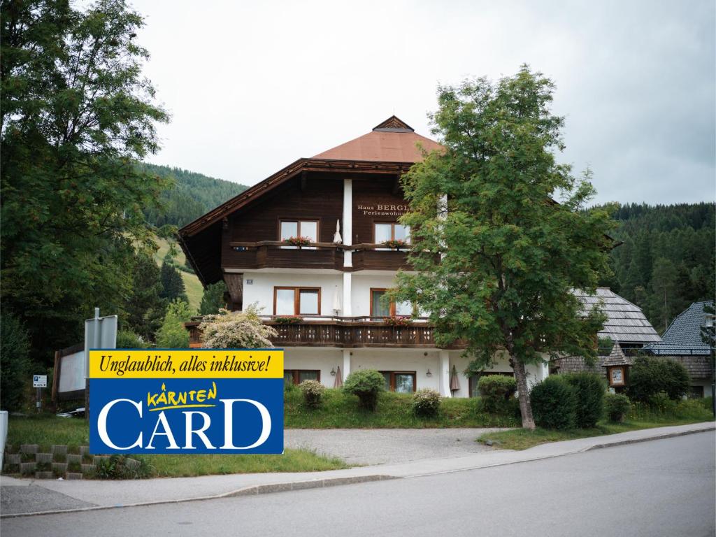 a large house with a sign in front of it at Appartments Bergland an der Brunnachbahn in Bad Kleinkirchheim