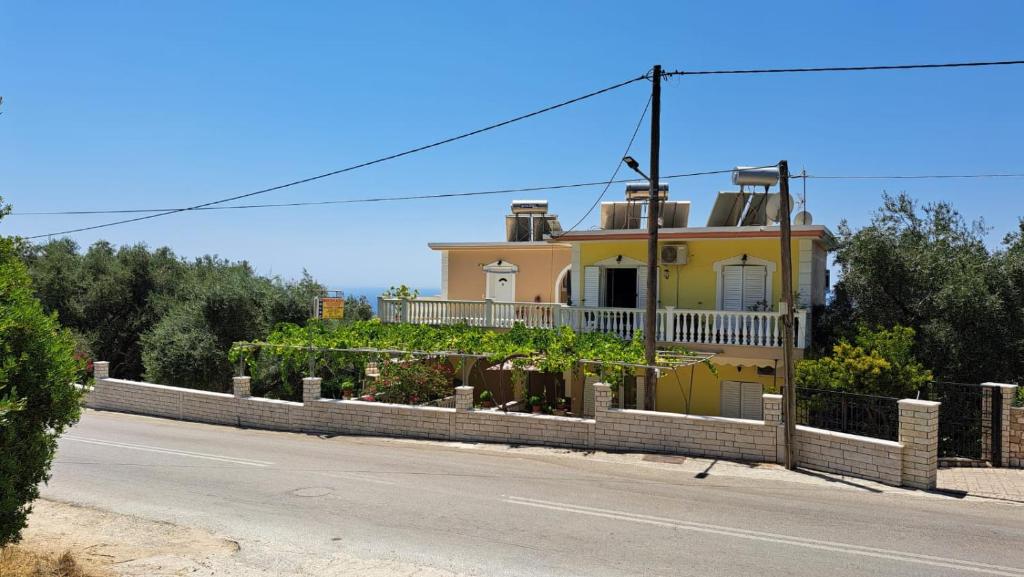 a yellow house on the side of a road at Nikolaou Thomas House in Parga