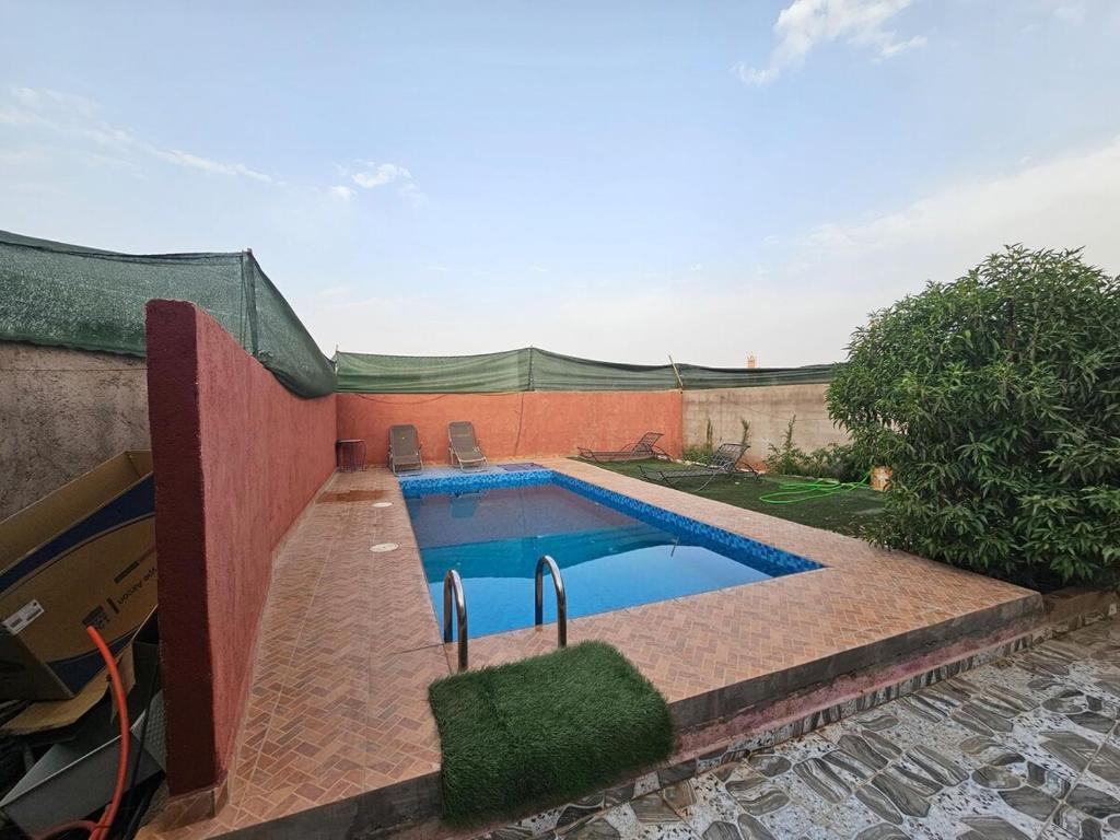 a swimming pool in the backyard of a house at Villa route ourzazate in Aït Ourir