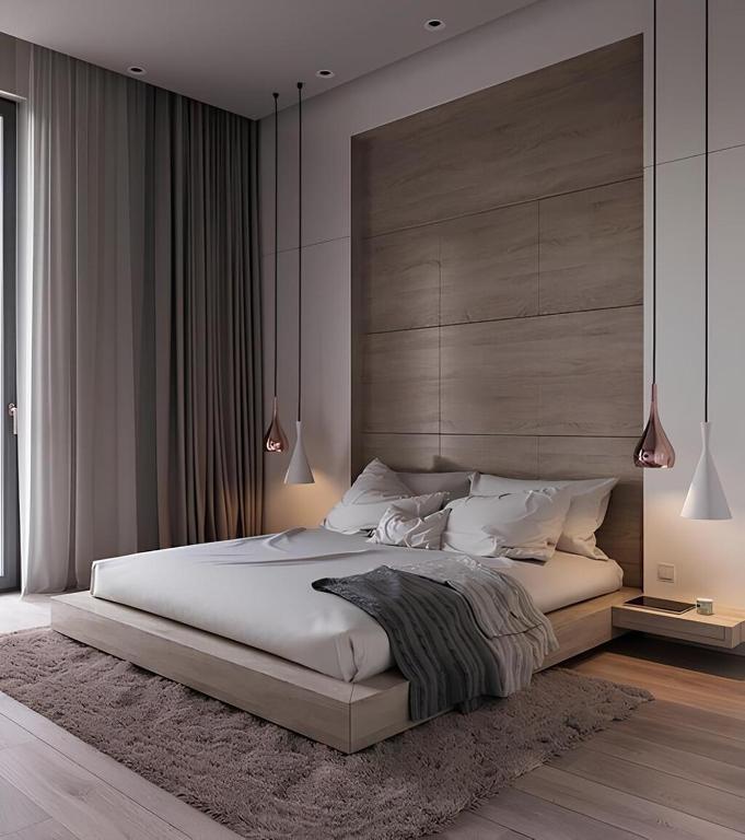 a bedroom with a large white bed with a large headboard at 品朵行旅 台中 逢甲館 Pin INN in Taichung