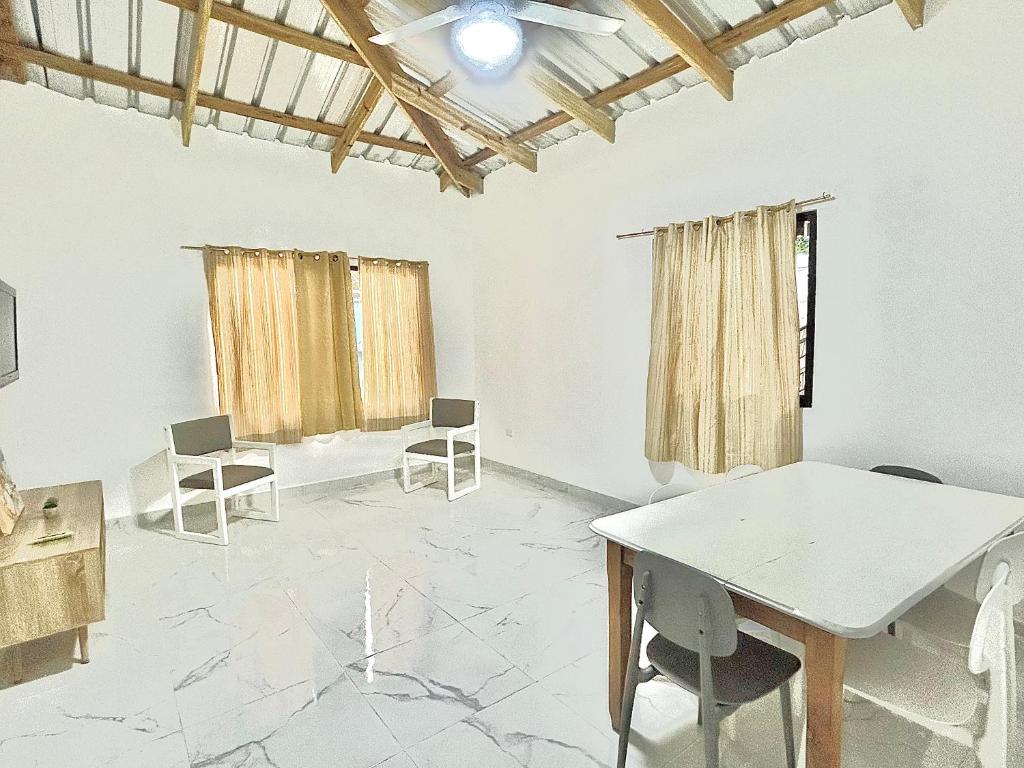 a white room with chairs and a table in it at Mi Refugio 3 in Río San Juan