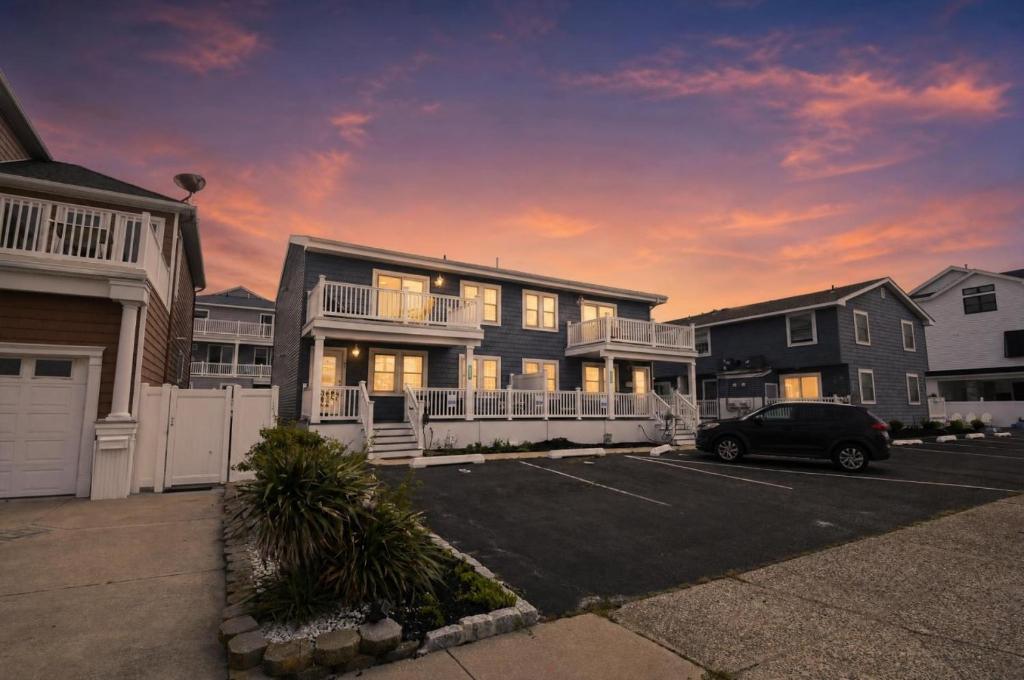 a house with a car parked in a parking lot at Steps to Sand Updated Bouchee Beachy Condo Deck Parking in Brigantine