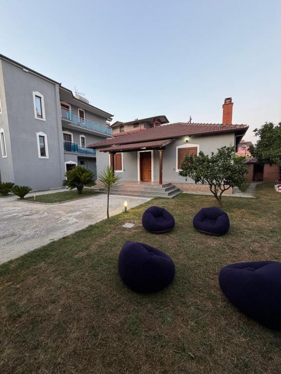 a group of blue bean bags on the grass in front of a house at Comfort House in Bathore
