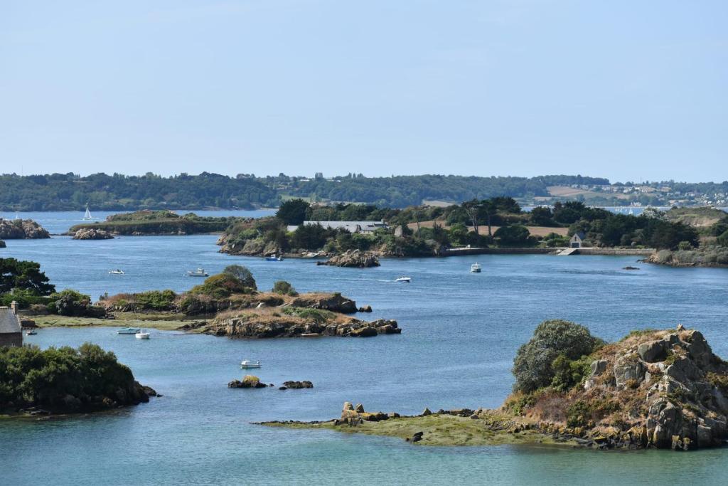 a river with rocks and boats in the water at Guingamp studio with garden view in Guingamp