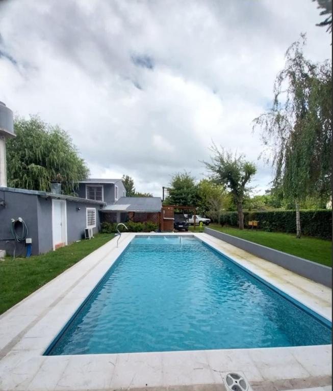 a swimming pool in the yard of a house at Encanto serrano in Sierra de los Padres