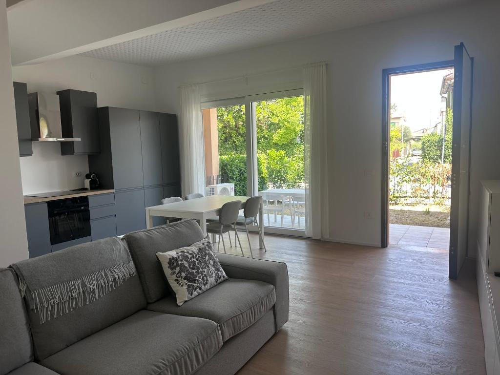 a living room with a couch and a table at Appartamento Stella - 15' walk to Abano Terme centre in Abano Terme