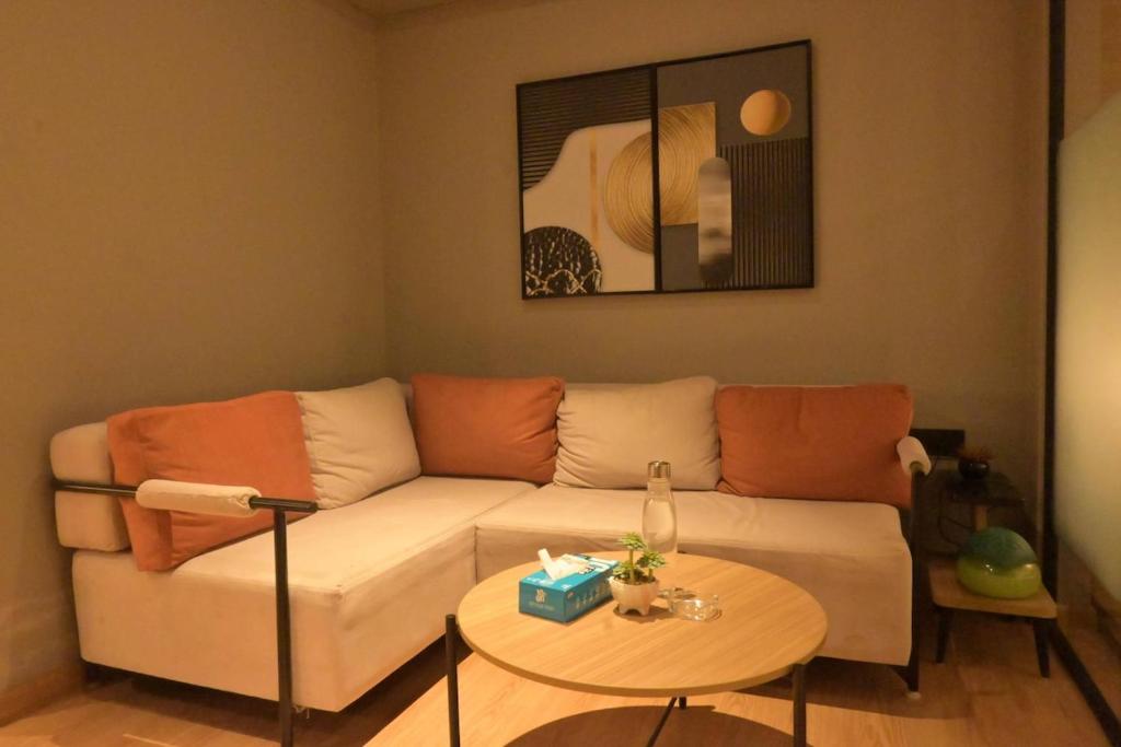 a living room with a couch and a table at The Signature Suite in Raipur