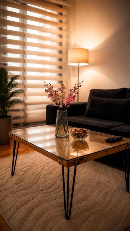 a living room with a coffee table with flowers on it at Sunset in Kriva Palanka
