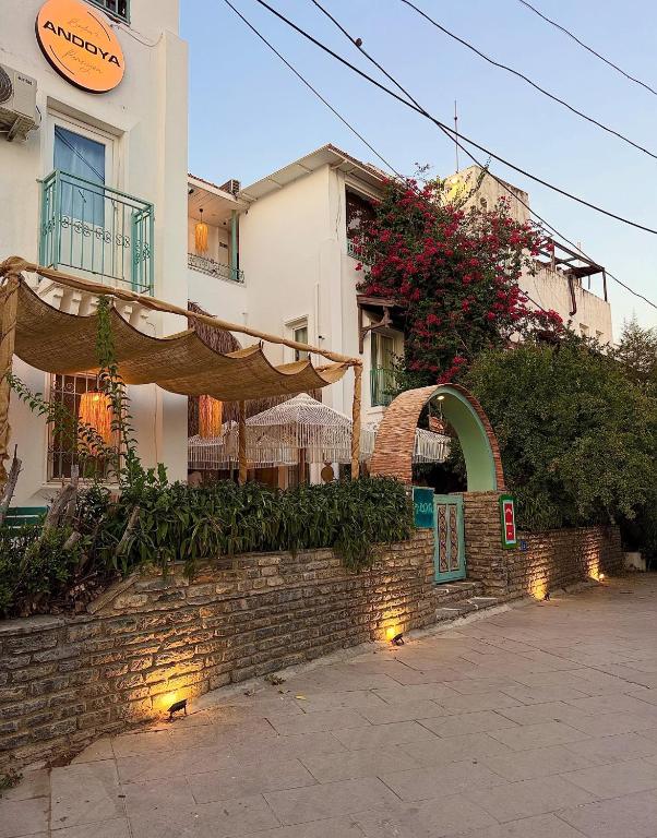 a building with a brick wall next to a building at Andoya Butik Pansiyon in Bodrum City