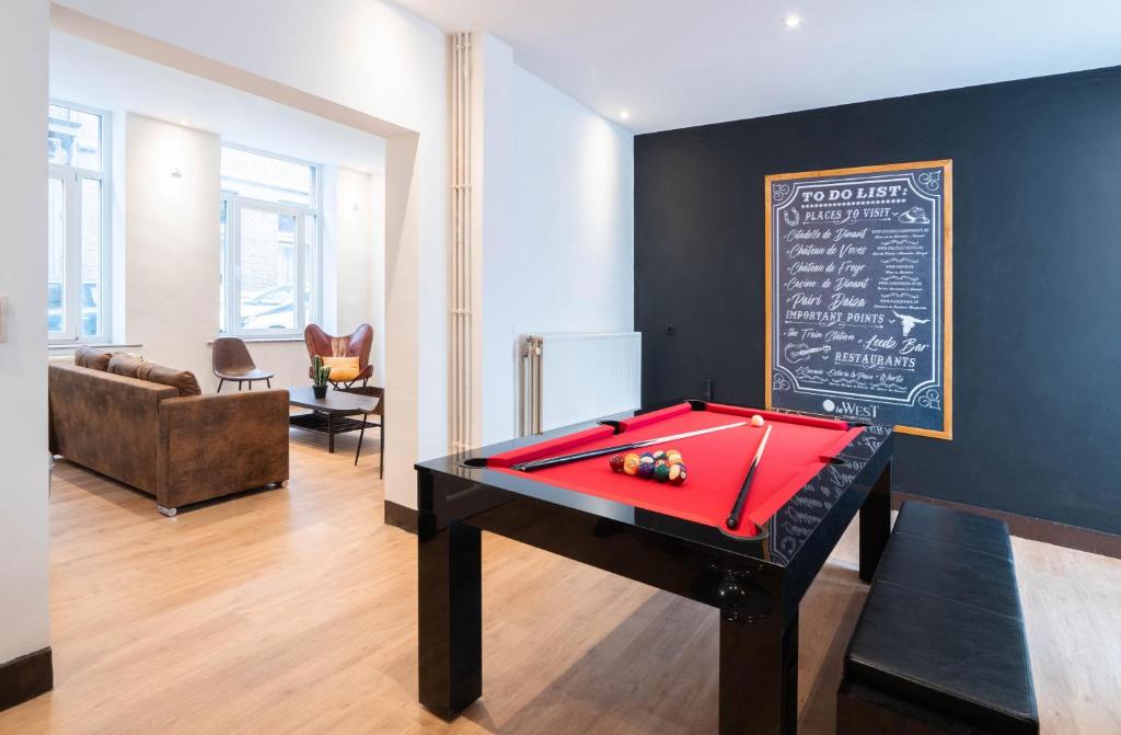 a room with a ping pong table and a chalkboard at Le West - Dinant Centre in Dinant