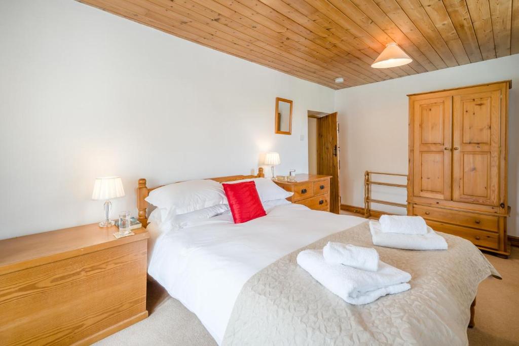 a bedroom with a large white bed with towels on it at 3 Bed in Askrigg oc-ds926 in Askrigg