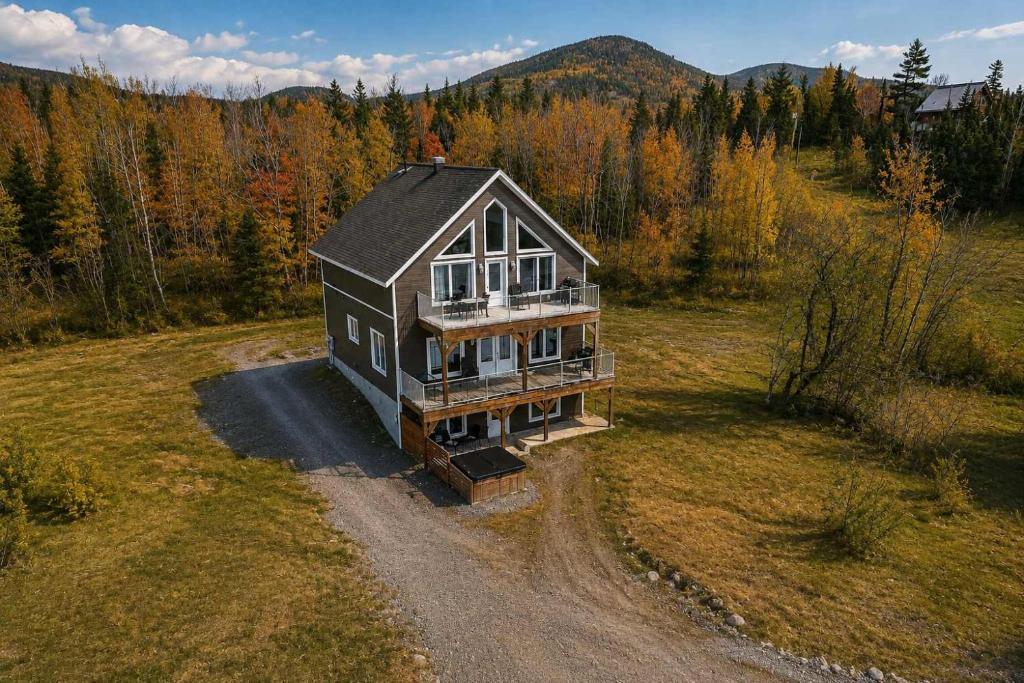 an aerial view of a house in the middle of a field at Le Haut-Perche - Spa and River View in Petite-Rivière-Saint-François