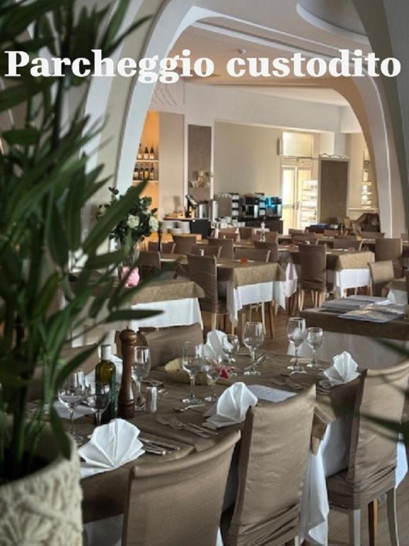 a dining room with tables and chairs and a restaurant at Hotel Biondi in Montecatini Terme