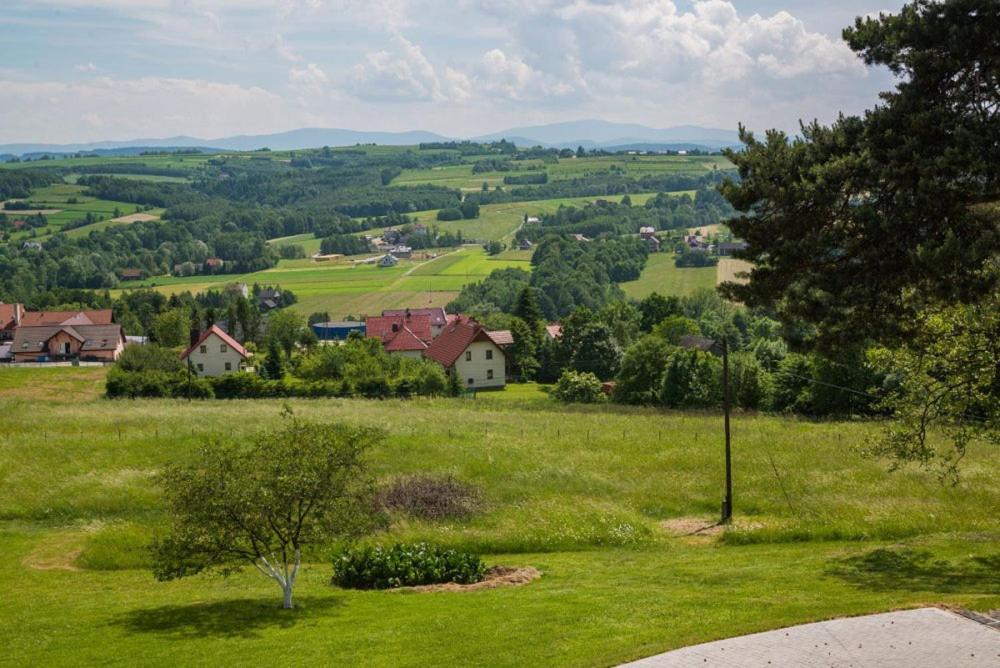a view of a green field with houses and trees at Przytulne studio 