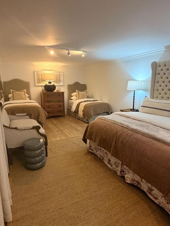 a bedroom with two beds and a dresser in it at 22 Emoyeni Drive in Hillcrest