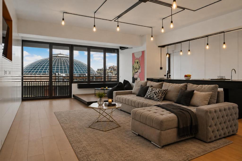 a living room with a couch and a table at RHUM B03 - Dome View in Bucharest