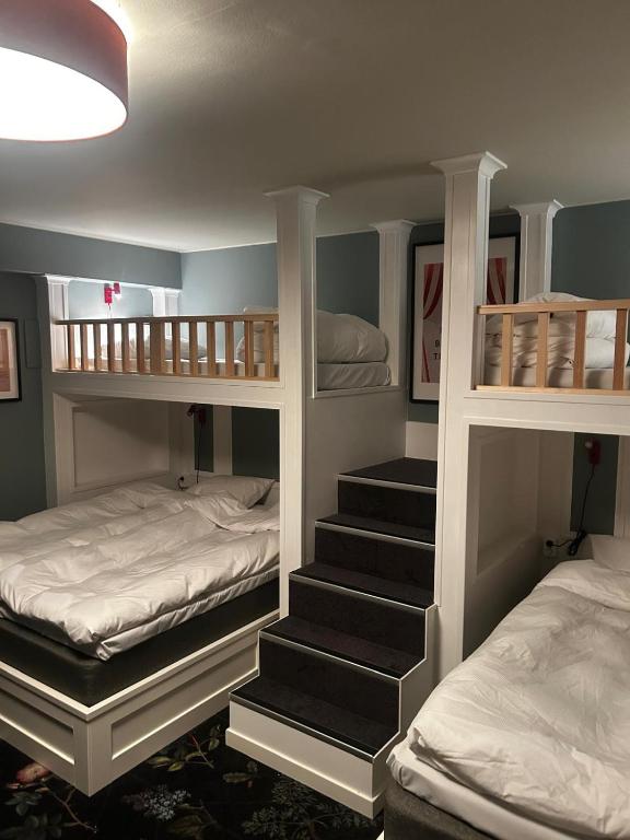 a room with two bunk beds and a staircase at The Malt House Inn in Gothenburg