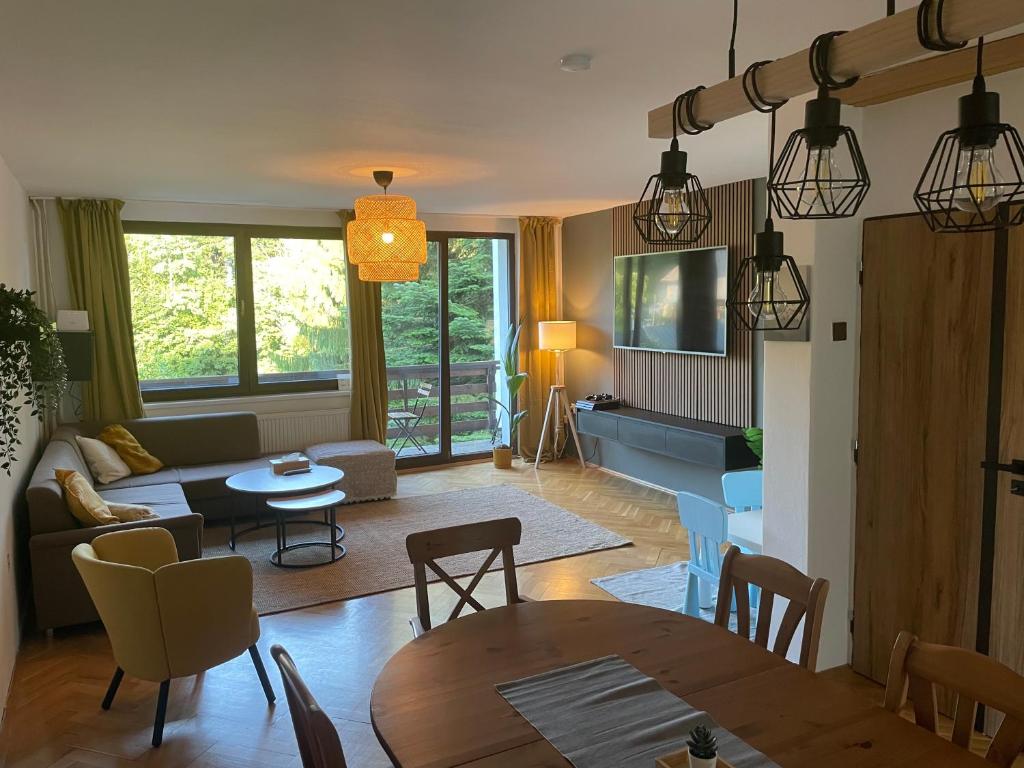 a living room with a table and a couch at Cedron Apartments in Benecko