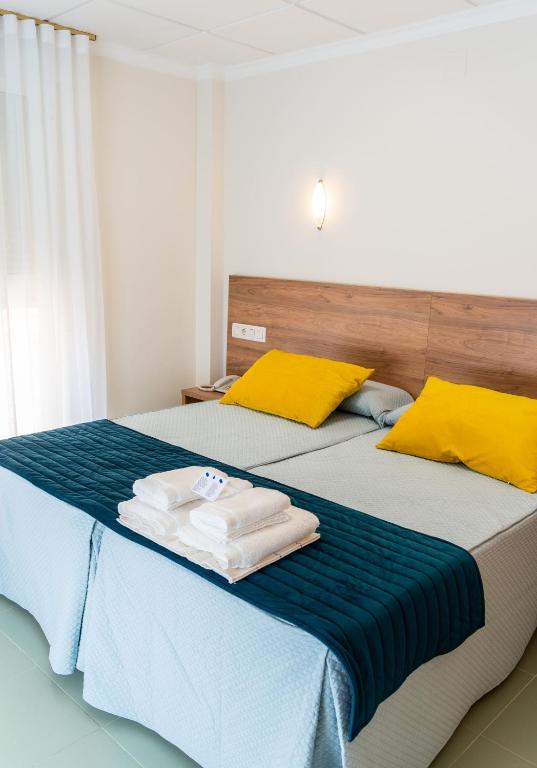 a bedroom with two beds with towels on them at Hotel GR in Tobarra