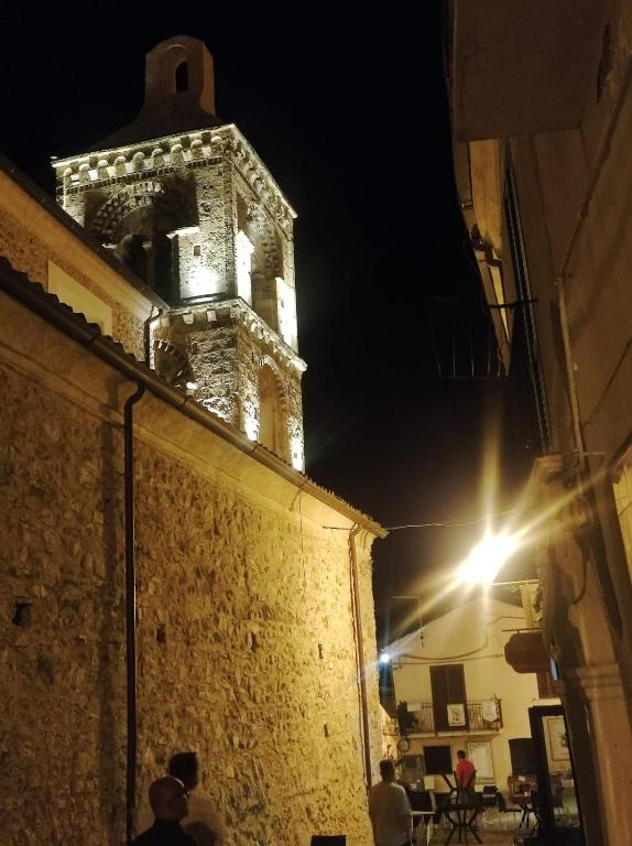 a clock tower with lights on top of a building at Casa Engy in Rocca Imperiale