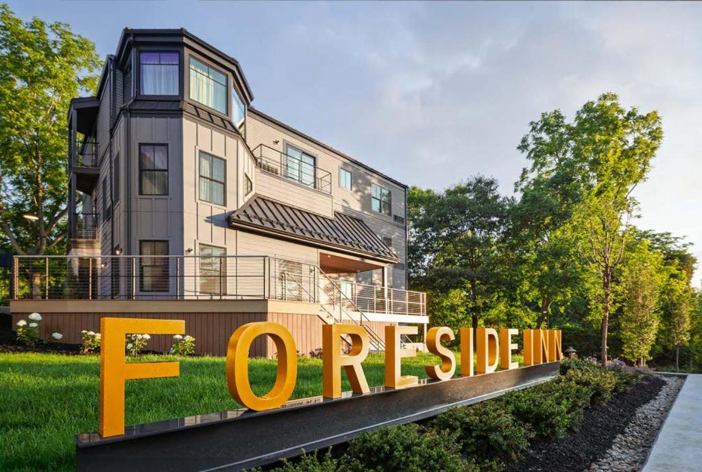 a house with a large orange sign in front of it at The Foreside Inn in Kittery