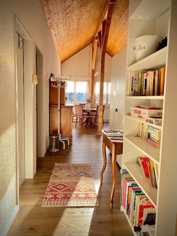 a hallway with a table and a dining room at Stilvolles Loft-Apartment in Gais