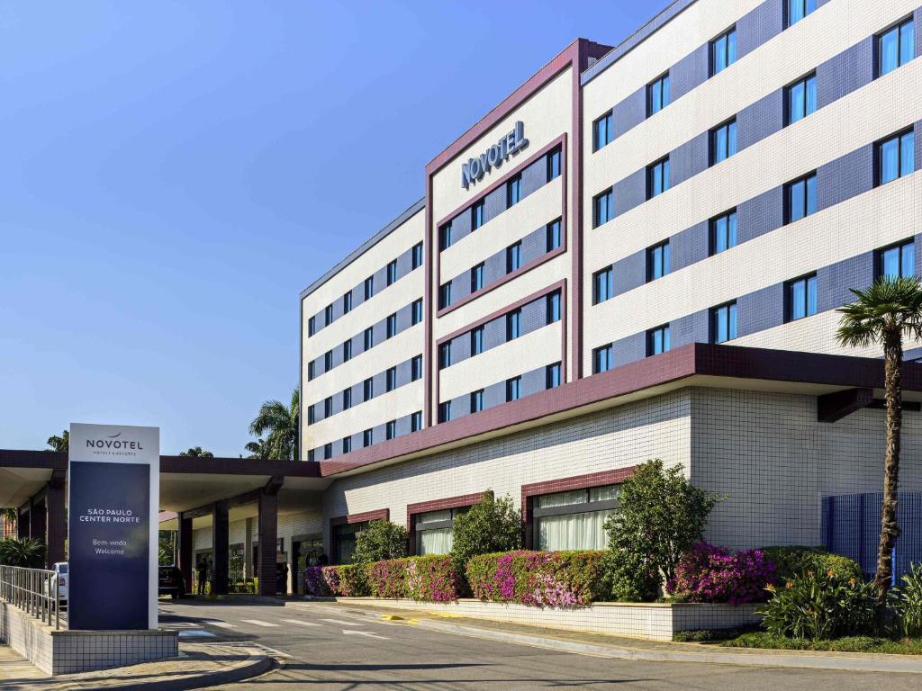 a hotel building with a sign in front of it at Novotel Sao Paulo Center Norte in São Paulo