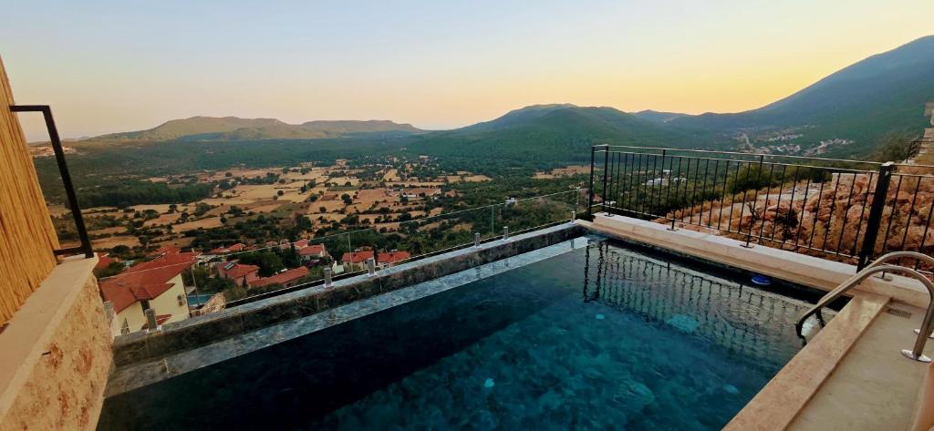 a swimming pool with a view of a city at Aera Villas - Kaş in Kaş