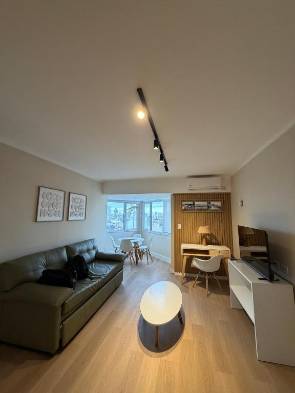 a living room with a couch and a table at Torre Alberti Apartments in Mar del Plata