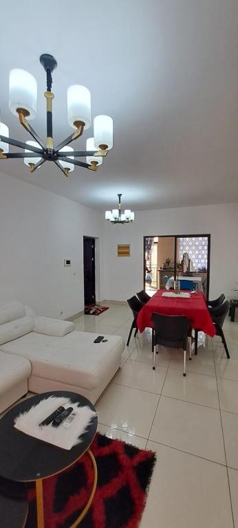 a living room with a couch and a table at Apartamento Condomínio Vila Flor in Viana