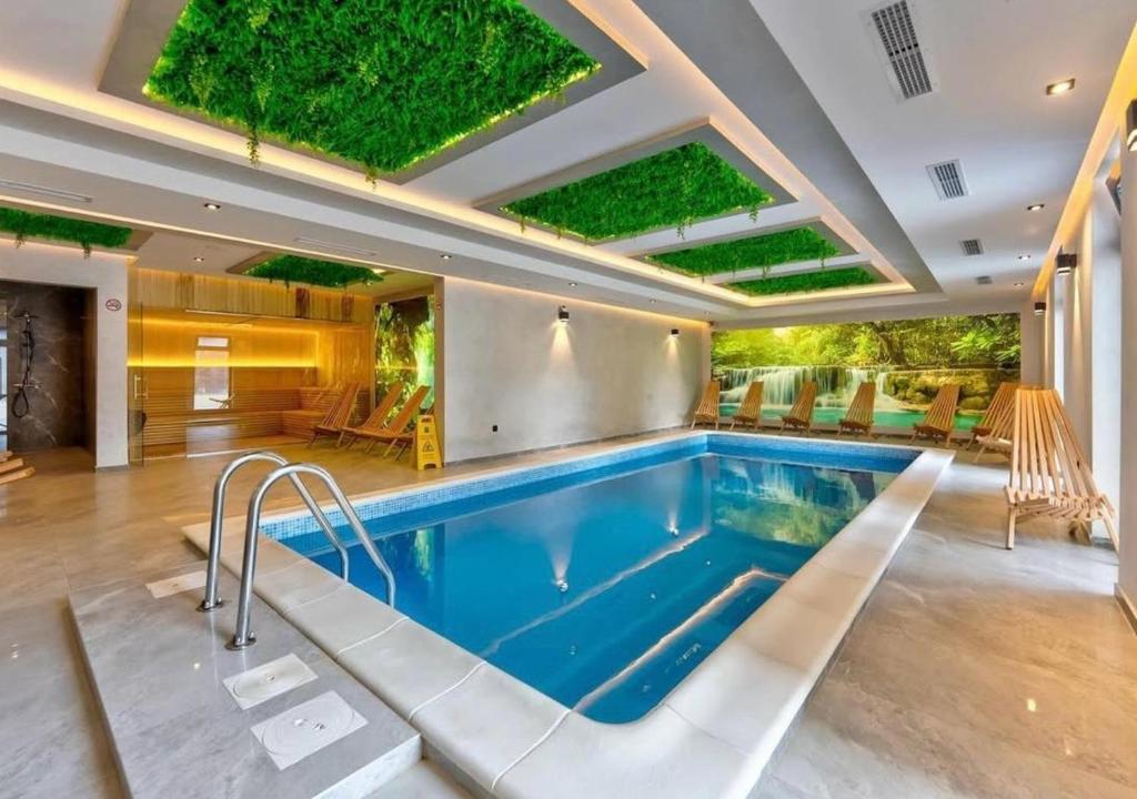 a swimming pool in a large room with at Kalisi Panorama Tornik in Zlatibor