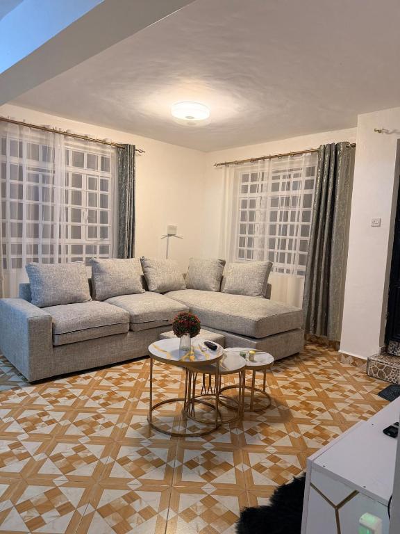 a living room with a couch and a table at 2020 suites utawala in Nairobi