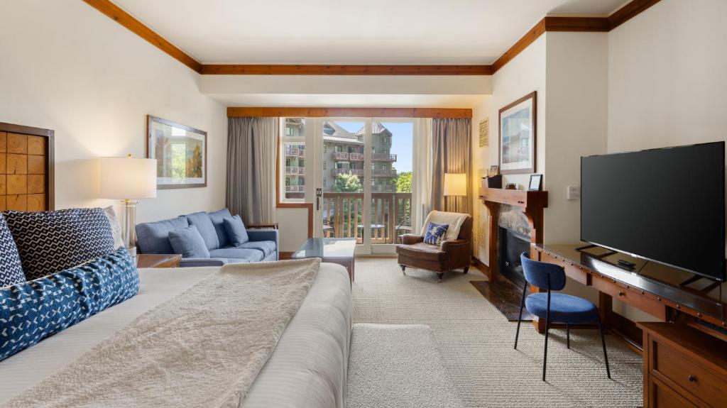 a living room with a couch and a flat screen tv at 347 Lodge At Spruce Peak Ski In Ski In Ski Out King Studio By Stowe Mountain Rentals in Stowe