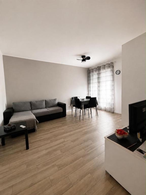 a living room with a couch and a table at Civico 8 in Bollate