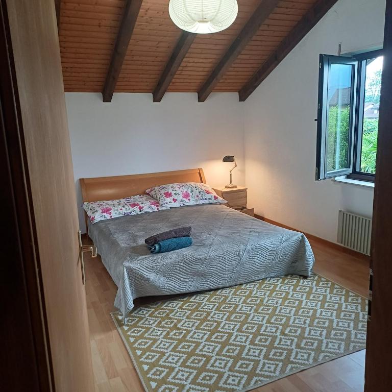 a bedroom with a bed with a blue bag on it at Bnb Bouveret in Port-Valais