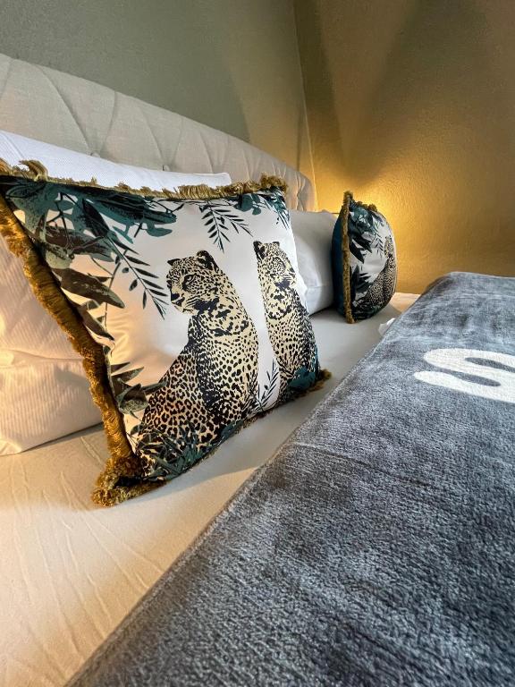 a bed with two leopard pillows on it at Stylischer Altbau im Zentrum in Kiel
