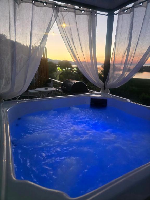 a bath tub with a view of the sky at Alex's House Shirokë in Shkodër