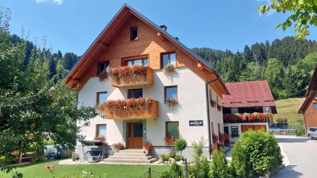 a house with flower boxes on the front of it at Apartments Ela in Rateče