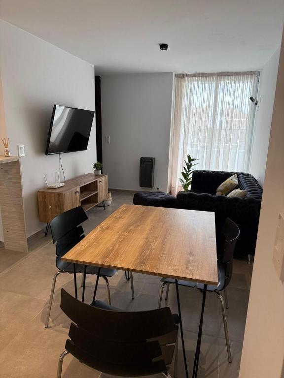 a living room with a wooden table and chairs at luxury apart 1 in Villa María