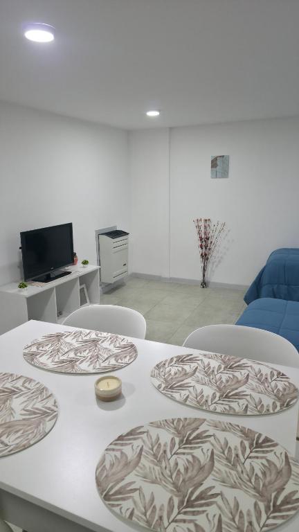a room with a table and chairs and a couch at VMV Departamento in Río Grande