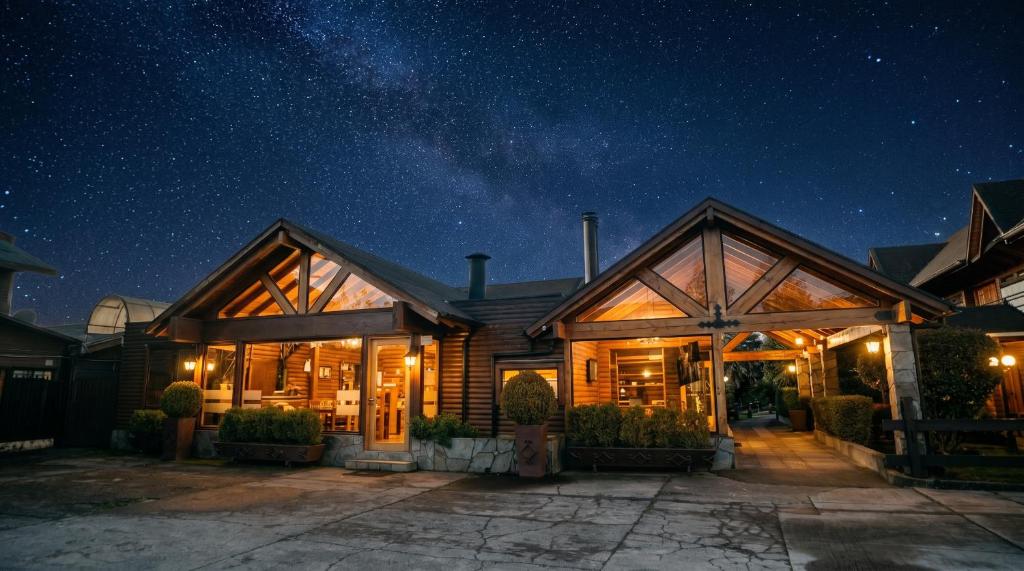 ein Haus bei Nacht unter einem Sternenhimmel in der Unterkunft Hotel Pitrufquen in Pitrufquén