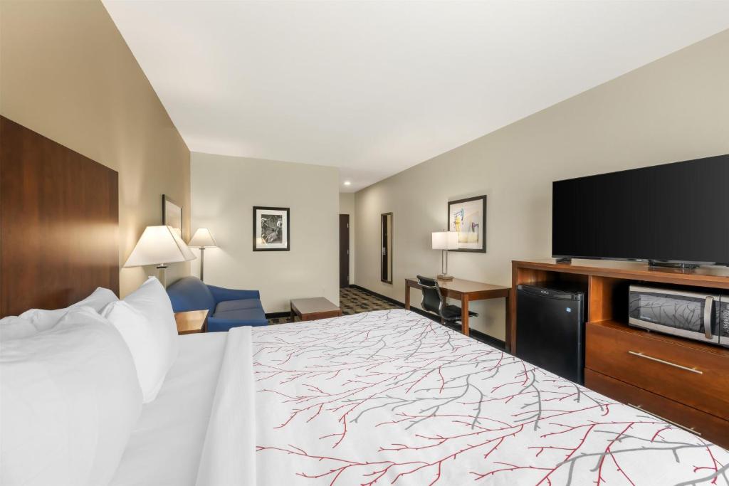 a hotel room with a bed and a flat screen tv at Best Western Plus Big Lake Inn in Big Lake